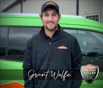 Project Manager in front of SERVPRO vehicle