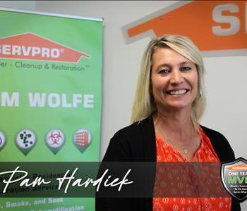 woman standing in SERVPRO background
