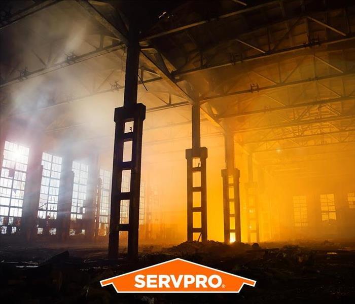 a burned out warehouse with SERVPRO logo in the picture